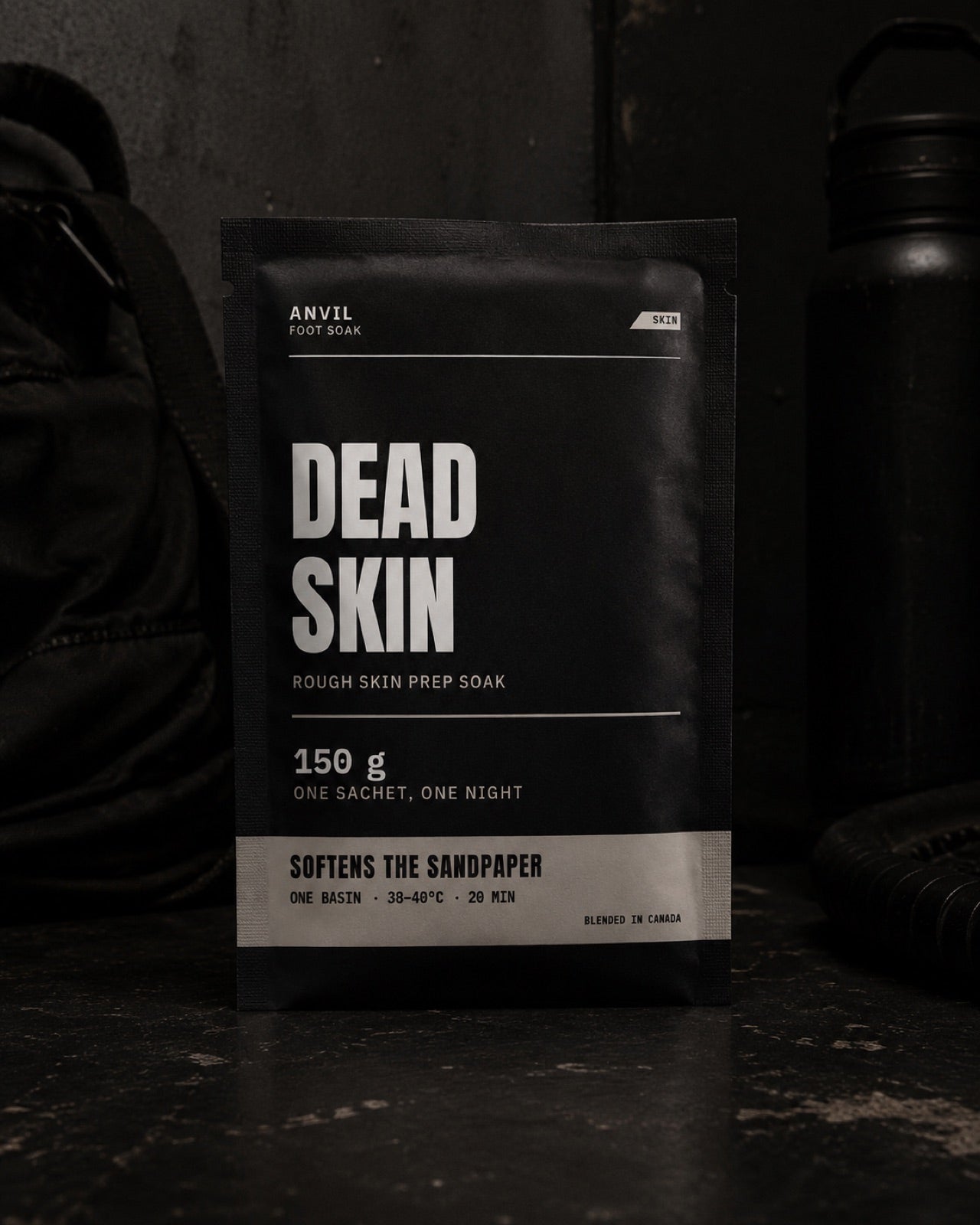 ANVIL Dead Skin foot soak sachet against a dark gym-bag backdrop