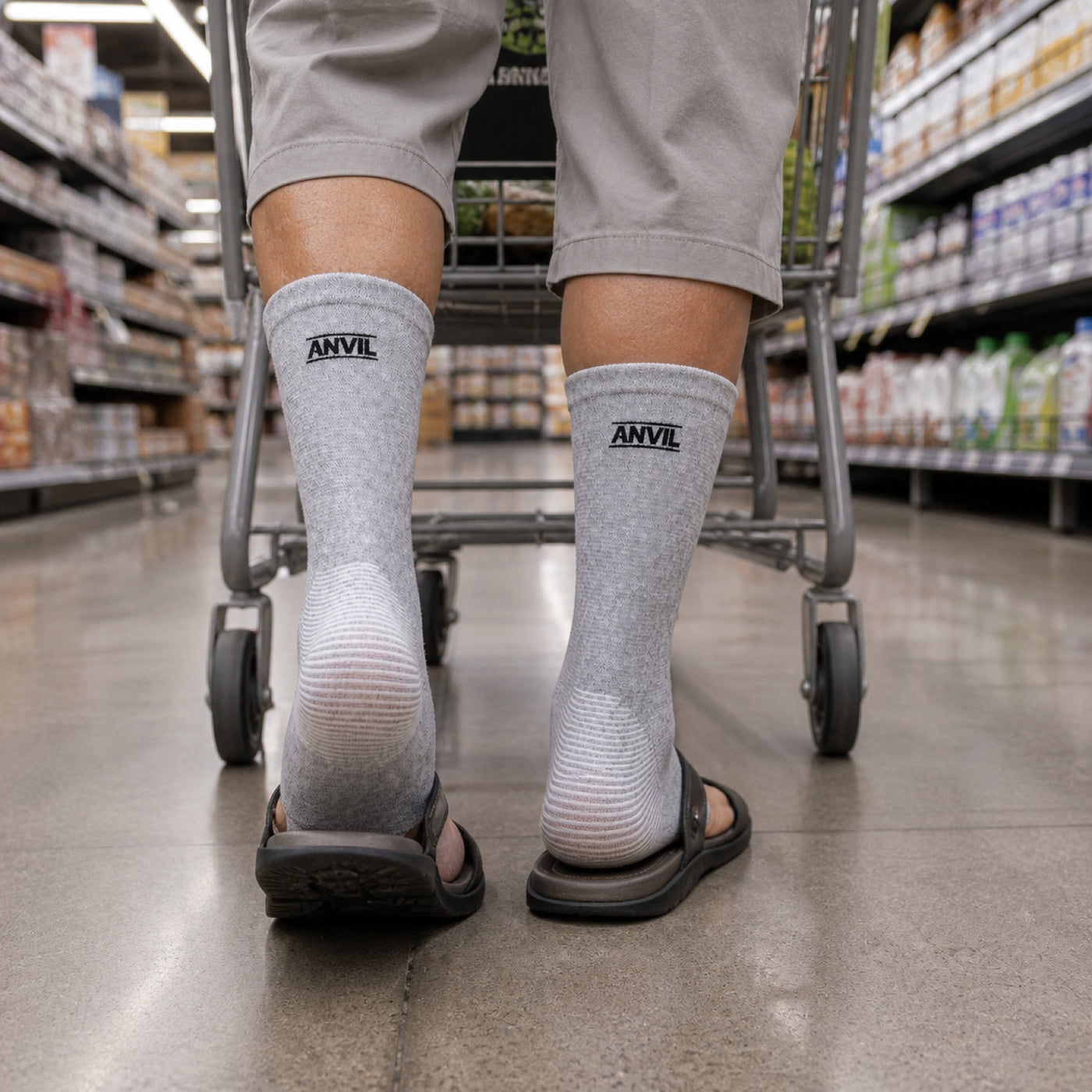 Person in a grocery store aisle in gray toeless ANVIL foot sleeves.