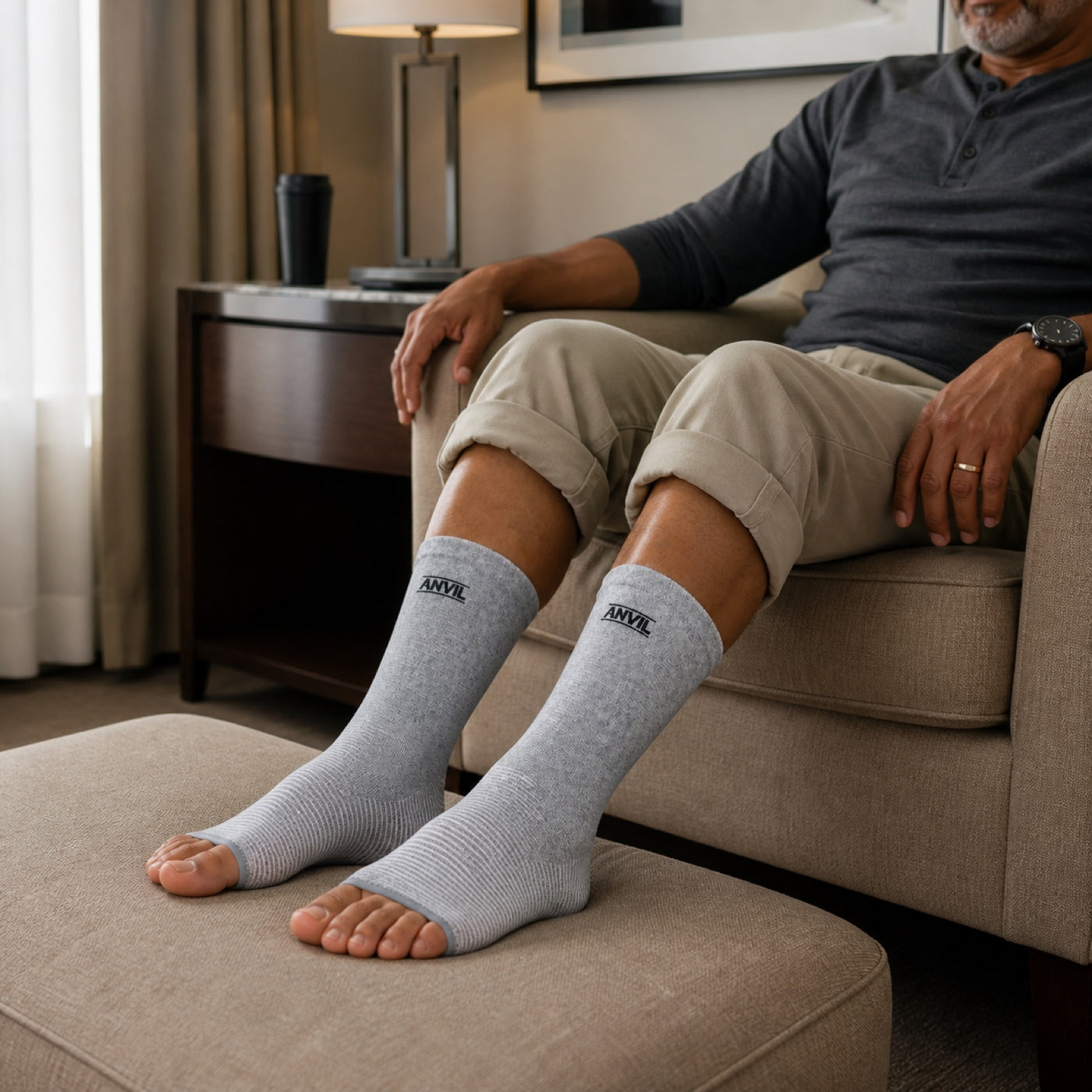 Person in a hotel room in gray toeless ANVIL foot sleeves.