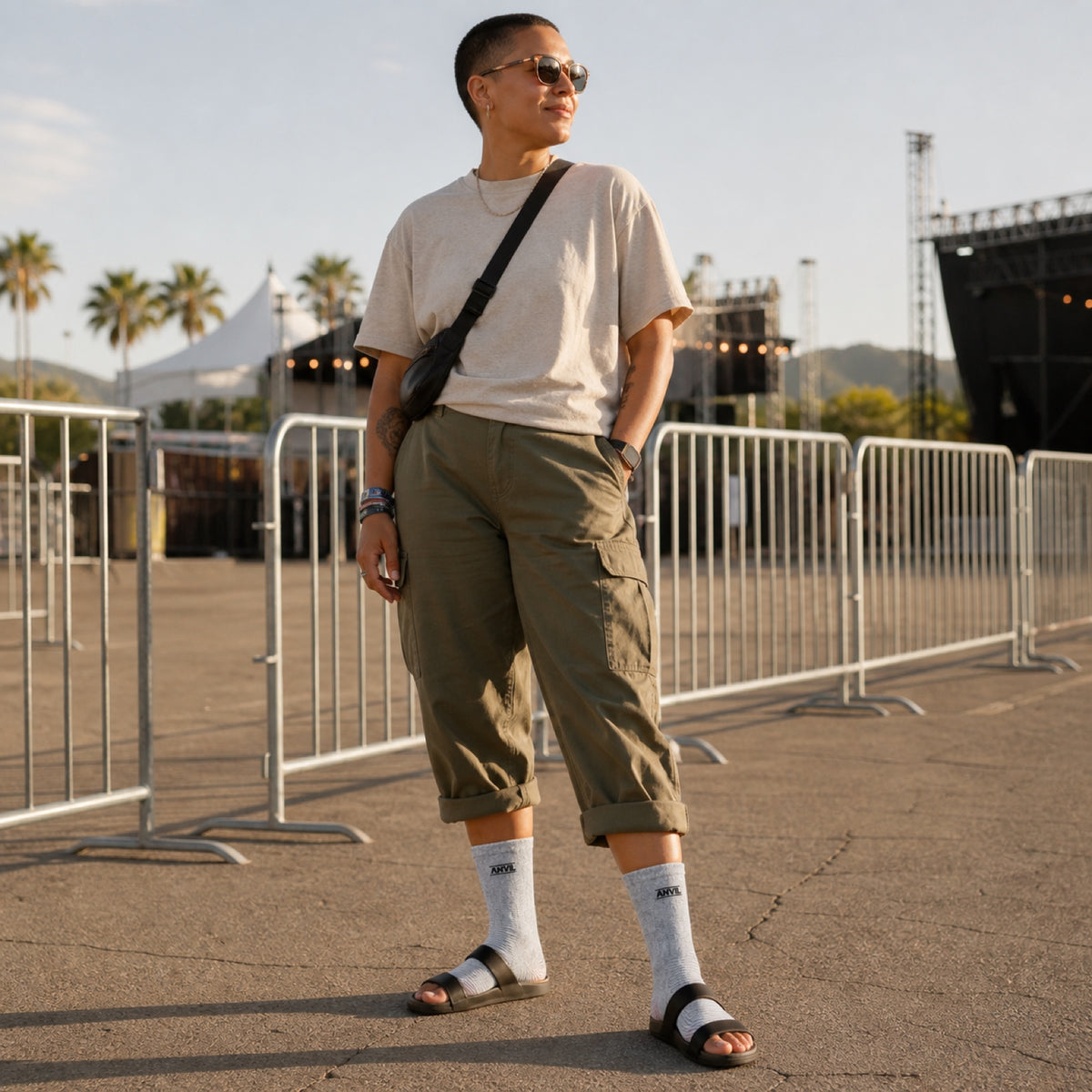 Person at a festival entrance in gray toeless ANVIL foot sleeves.