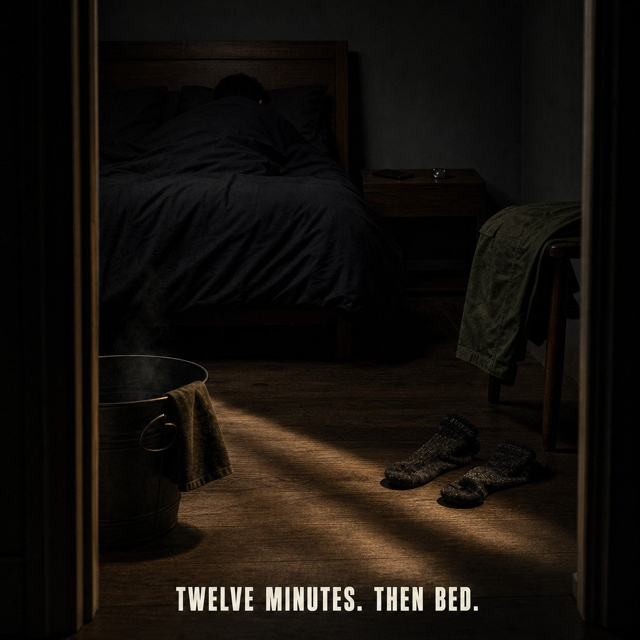 A dark bedroom at lights-out, the day's clothes shed on the floor, a steaming basin by the door