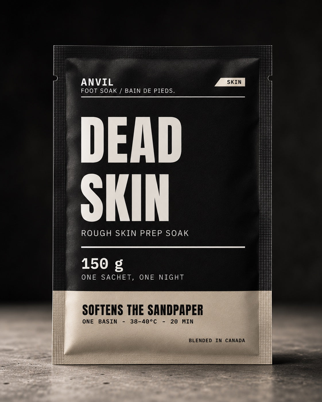 DEAD SKIN rough skin prep soak — matte black sachet standing on dark stone, studio shot