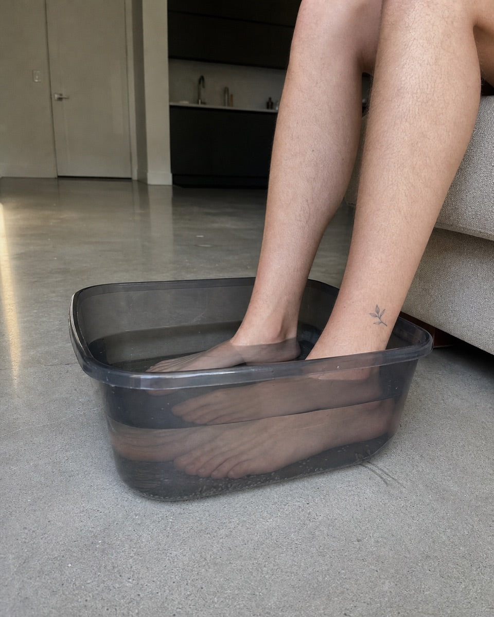 Feet soaking in a basin &mdash; condo living room