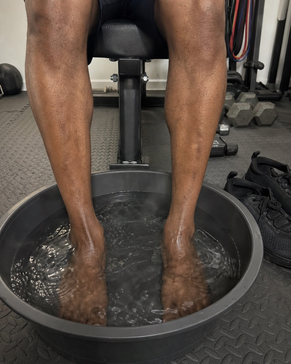 Feet soaking in a basin &mdash; home gym between sets